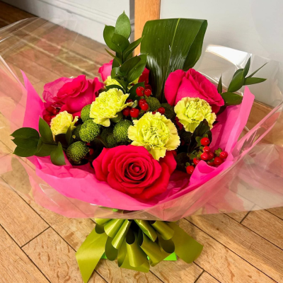 Blushing Meadow - A stunning collection of pink and green seasonal flowers in toning packaging. This bouquet is designed to impress and uplift any space.