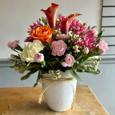 Pot of Happiness - A small but choice selection of flowers arranged in a petite container.