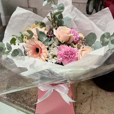 Ashleigh - A budding delight, complimented by greenery and presented in a gift box/bag. Beautiful flower bouquet hand delivered by the local florist.