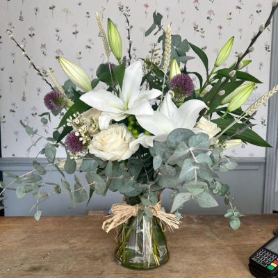 Classic Harmony - Share your sentiments with this beautiful arrangement of white and green blooms complemented by lush greenery. Presented in elegant wrapping.